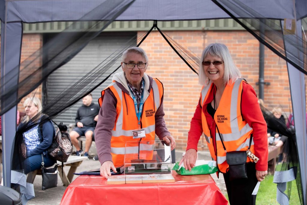 Two volunteers demonstrate activities to the public