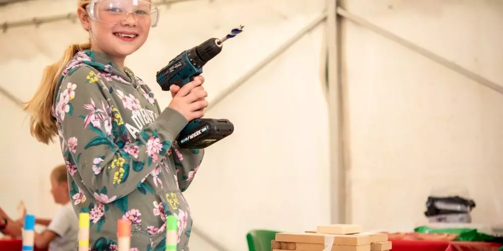 Girl preparing to drill wood