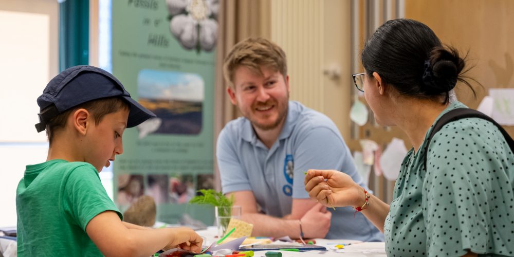 man smiling looking at fossils