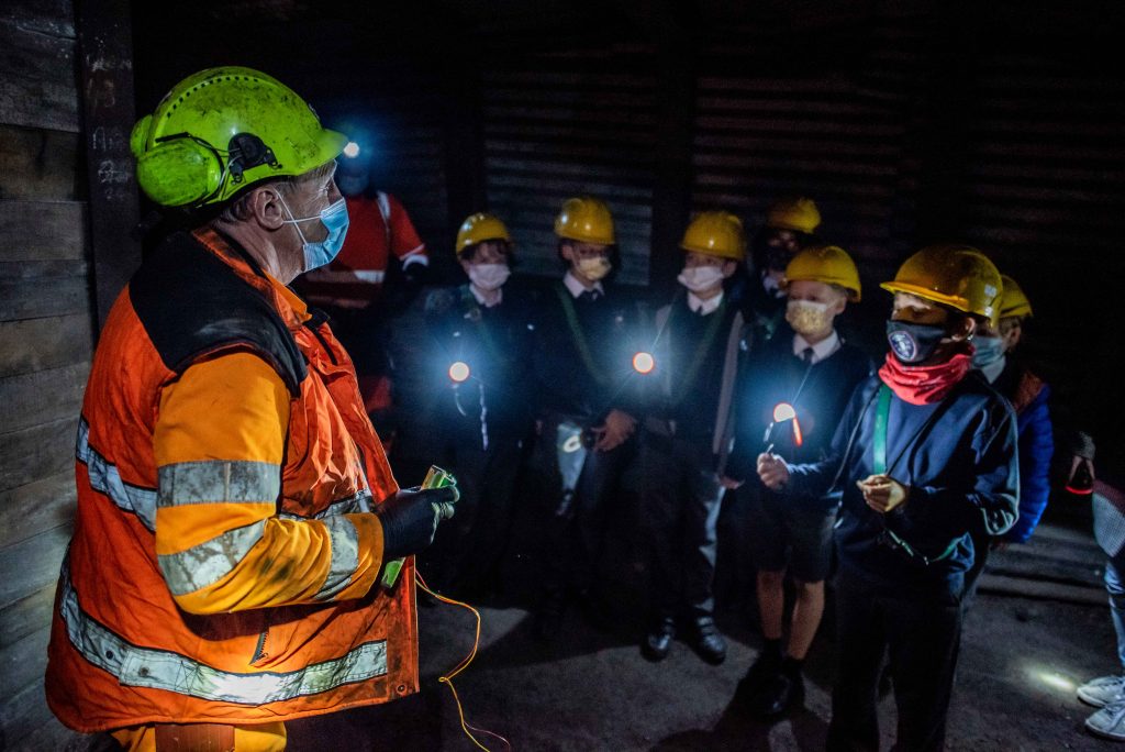 Miner talking to school children about dynamite