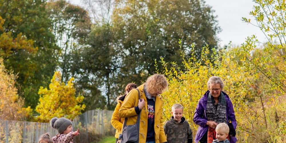a group of children walking along the Nature Trail for a Welly Walk