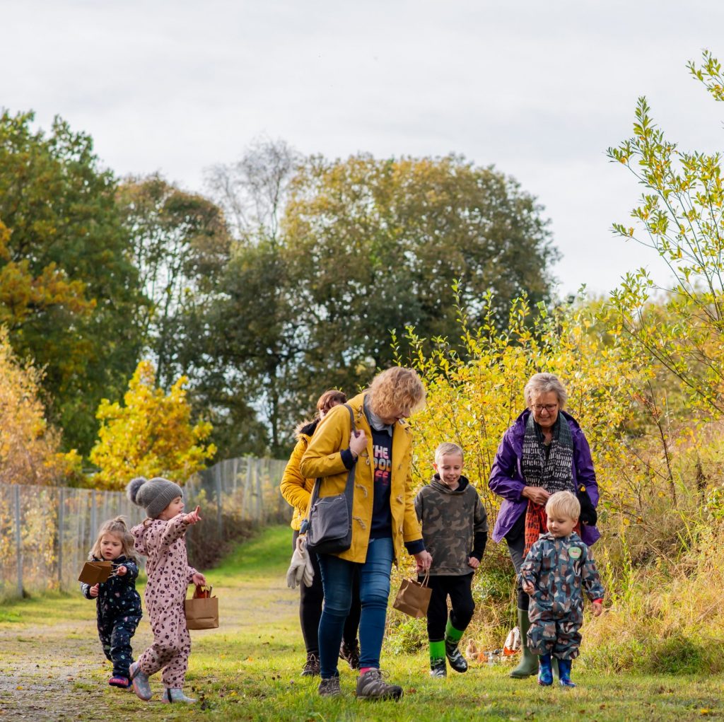 a group of children walking along the Nature Trail for a Welly Walk