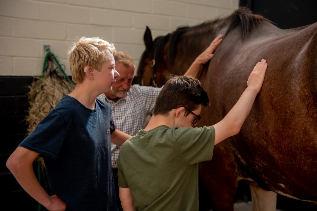 A SEND group learning about the history of mining get to touch a horse