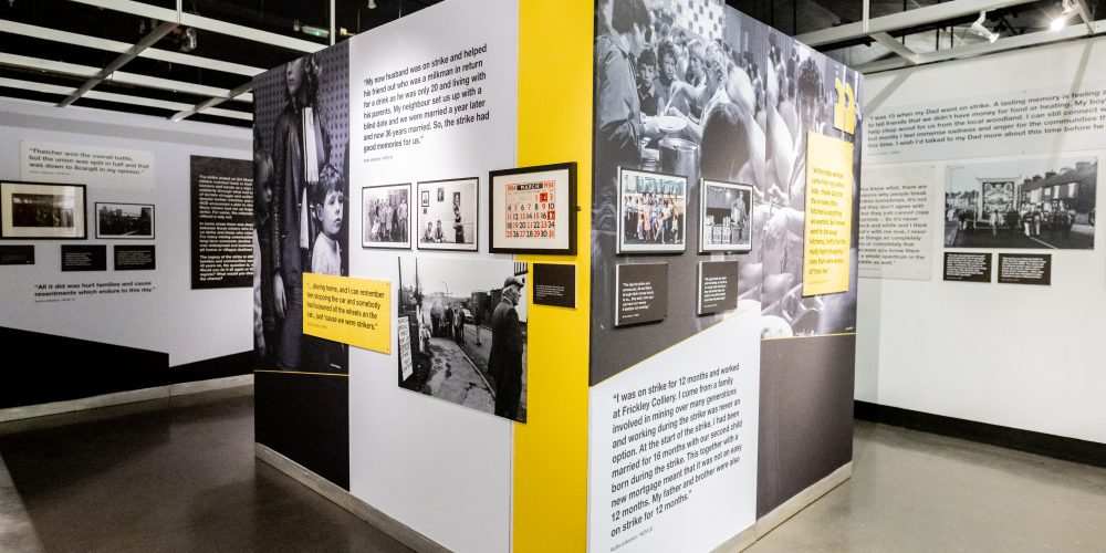 Exhibition walls which are white and yellow in colour