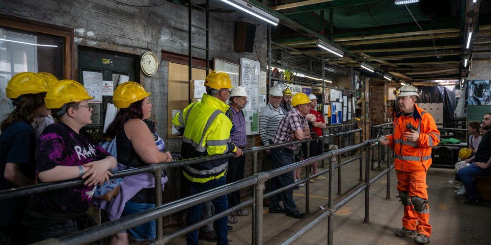 people stood waiting for an underground tour