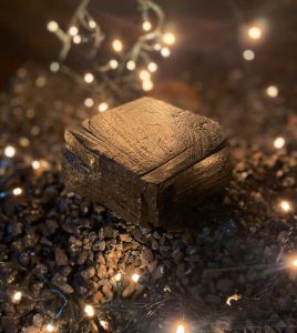 A piece of coal surrounded by fairy lights