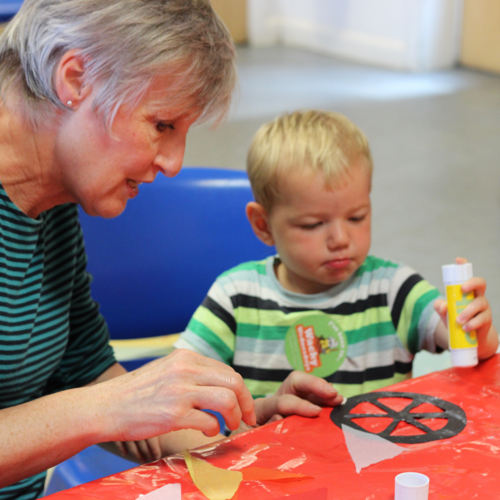 A grandparent and child crafting together
