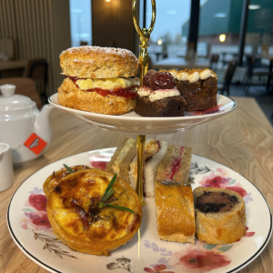 Afternoon Tea of cakes and savoury treats on tiered plates
