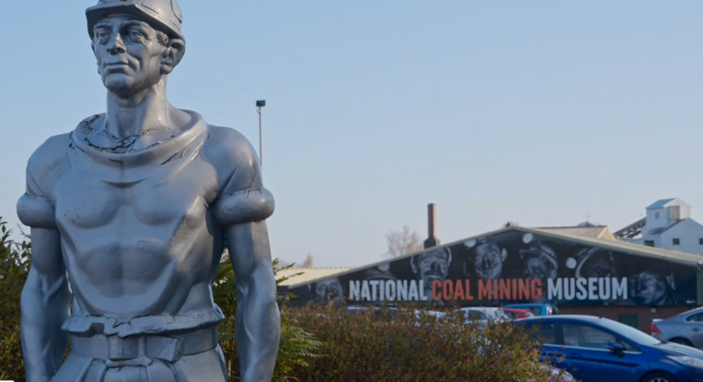 Statue of a Miner in front of the museum signage